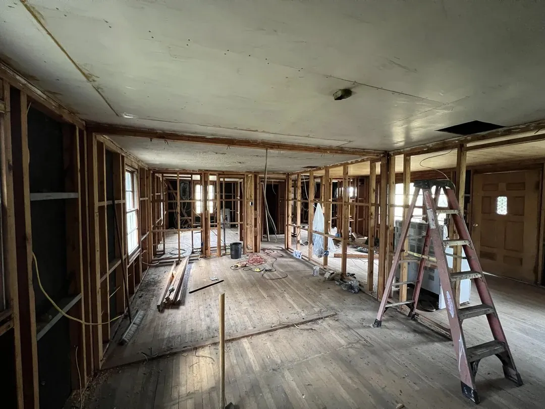 Unfinished interior with a step ladder before insulation
